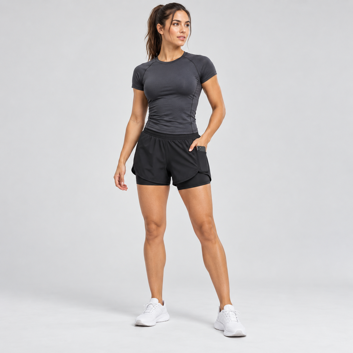 Woman wearing a burgundy and black gym training set on a white background